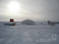          The Dome. This dome formerly housed the South Pole Station. It acts as a roof under which structures were constructed rather than being the outer wall of a structure itself, the buildings inside were two stories tall. Now it is used only for storage.

        In front of the dome is a buried arch that was later uncovered, raised, and altered. At the time of this photo there were three arches (barrel vaults) in a row, connected by smaller tunnels. By the end of the season there was one very long arch. The orange building on the left is Skylab. It is five stories tall, but is now mostly buried. Skylab and the Dome date from the mid-1970's.

        31st Oct 2007

